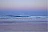 The afterglow of this evening's sunset reflects in the water off Fraser Island, Australia