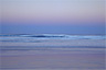 The afterglow of this evening's sunset reflects in the water off Fraser Island, Australia