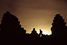 Looking into the sunset at the top of 5-tiered temple mountain Phnom Bakheng at Angkor, Cambodia