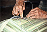Making a bamboo hat at the longhouse of Kampung Lalang, Malaysia 